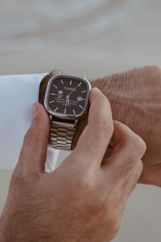 A close-up of a wristwatch on a man's hand, showcasing classic style.